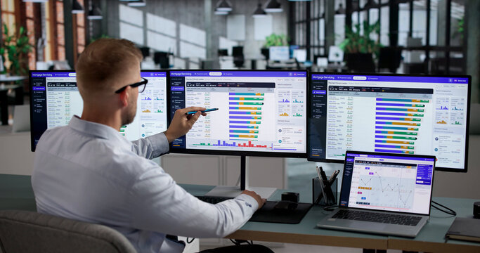 Mortgage Analyst Studies Loan Data Carefully On Laptop