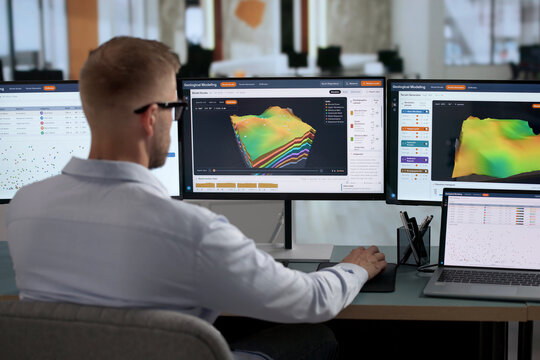 Geologist Carefully Studies 3D Subsurface Models On Laptop