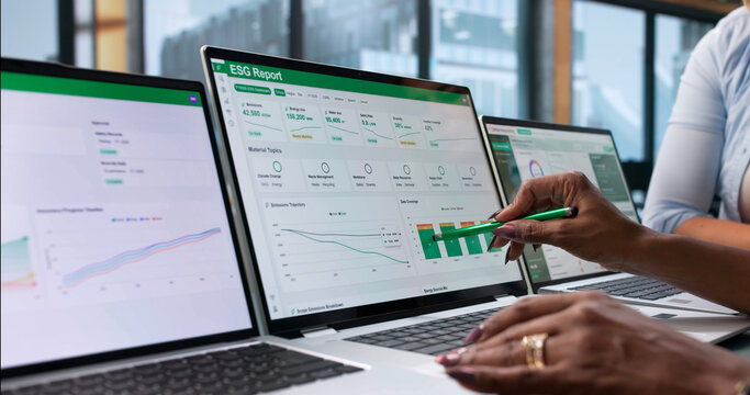 ESG Analyst Reviews Sustainability Data On Laptop
