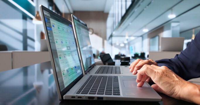 Office Manager Carefully Organizes Secure Digital Files On Laptop