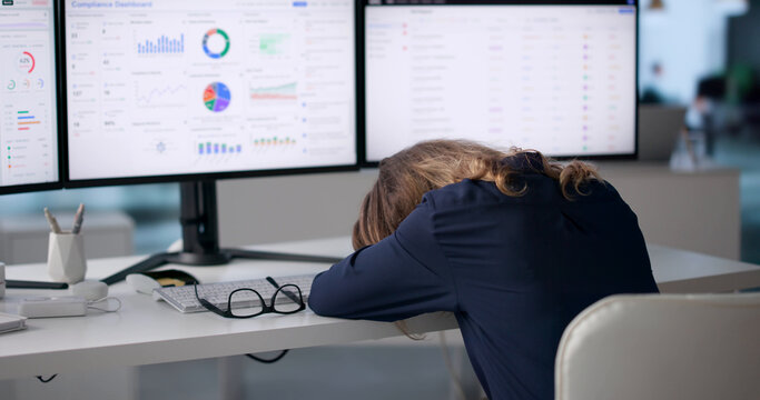 Compliance Officer Tired While Reviewing Risk Dashboard