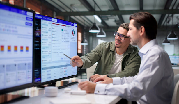 Loan Officer Reviews Credit Risk Data On Computer