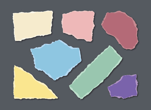 Set of torn paper pieces in various pastel colors and shapes on a dark gray background