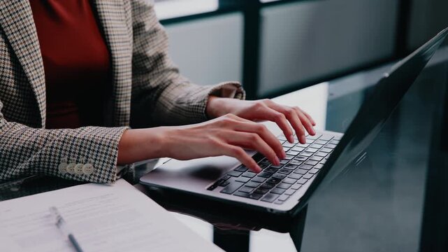 Laptop, woman and hands typing in enterprise for financial report, income statement or accounting. Office, computer keyboard and person in corporate company, audit review or balance sheet evaluation