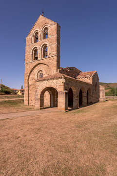 Romanesque church of San Salvador de Cantamuda featuring a majestic stone bell gable on a sunny day in La Pernia, Palencia, Castile and Leon, Spain