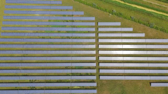 Solar panels stretch across green fields