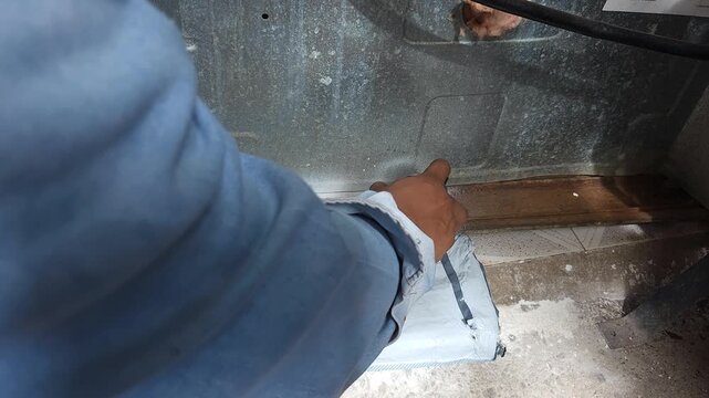 Applying Anti-Rust Paint Coating To Metal Stove Surface