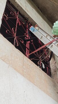 Hand Applying White Paint On High Window Frame Exterior