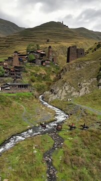 Historic Stone Towers and Scenic River Stream in Mountainous Village Landscape