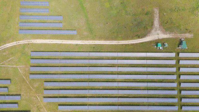Aerial view of solar panels on vast green land