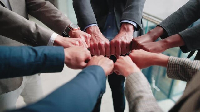 Business people, unity and fist bump in meeting, teamwork and solidarity for legal services or case. Corporate, lawyers and collaboration with colleagues, above and partnership with group in law firm