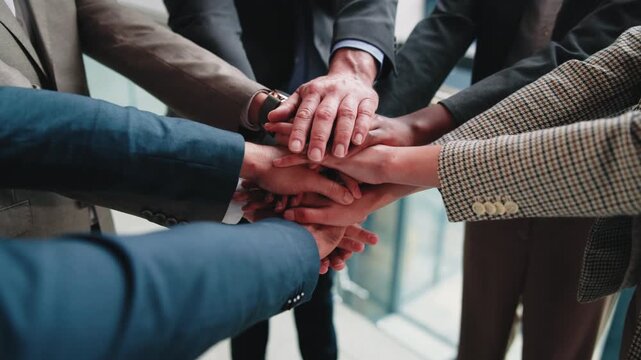 Business people, unity and hand stack in meeting, teamwork and solidarity for legal service or case. Corporate, lawyers and collaboration with colleagues, above and partnership with group in law firm