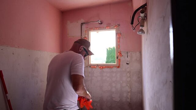 Man preparing a room for painting during home renovation