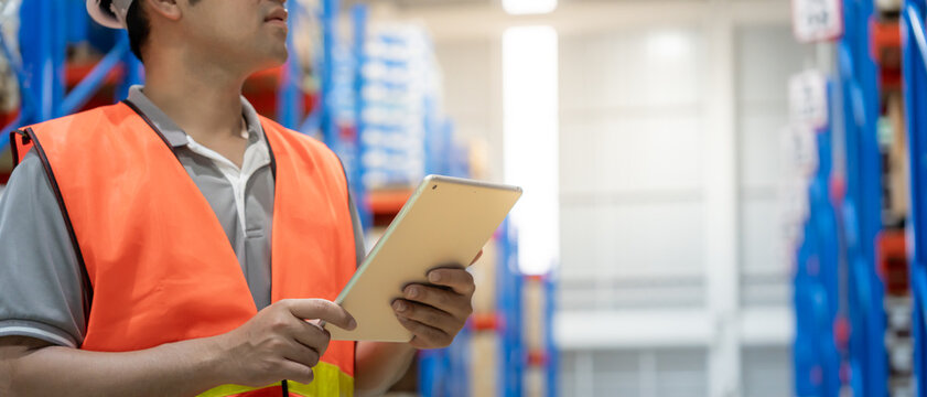 Asian male factory staff check goods in warehouse or inventory and stock product by tablet. Transport logistic business shipping, delivery to customers. inspection, storehouse, storage, factory
