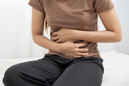 stomach ache. Asian women have abdominal pain, indigestion, gastritis, menstrual cramps, flatulence, diarrhea, distention, colon cancer, belly inflammation problem, suffer food poisoning, abdomen