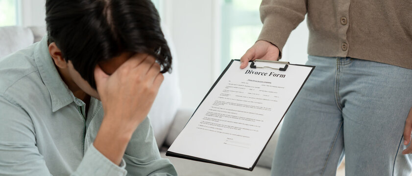 Divorce. Wife pass on Divorce form for husband. Couples desperate and disappointed after marriage. wife sad, upset and frustrated after quarrels conflict. distrust, love problems