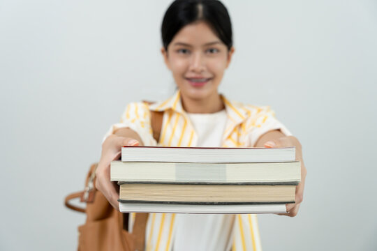 Portrait beautiful Asian woman student. Smile girl happy study. Hold book on the head college campus. young female on international Asia University. Education, study, school, learning, exam.
