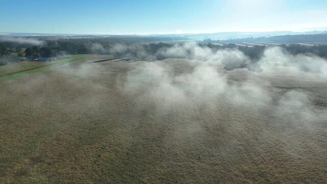 Drone clip of morning fog over farm fields in Upstate New York. Push clip.