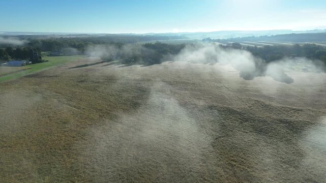 Drone clip of morning fog over farm fields in Upstate New York. Pull clip.