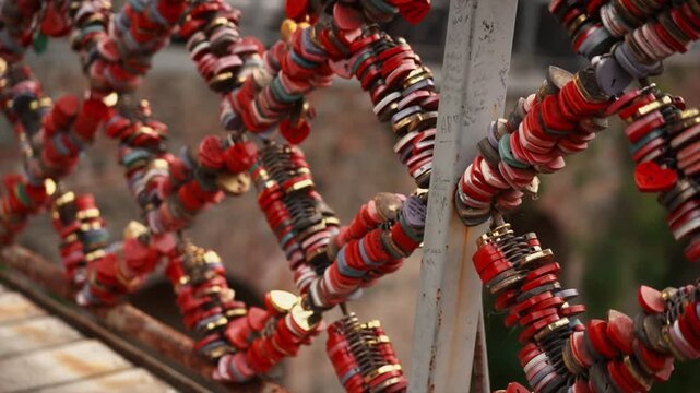 Close up of colorful love locks on a romantic bridge fence