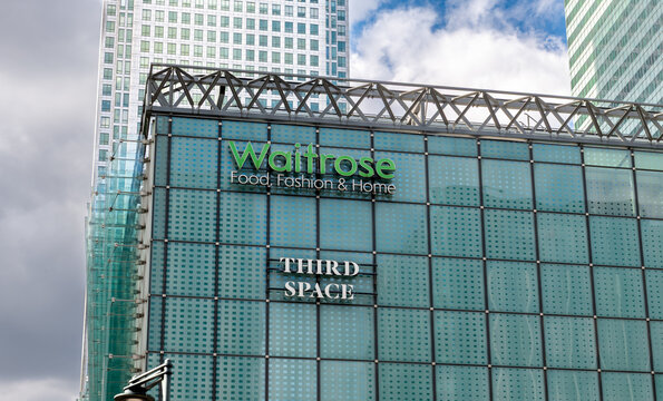 London. UK- September 23.2026. The name sign and facade of the branch of Waitrose grocery supermarket in Canary wharf.