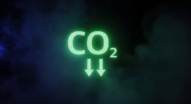 Glowing green co2 text symbol with downward arrows in dark smoke