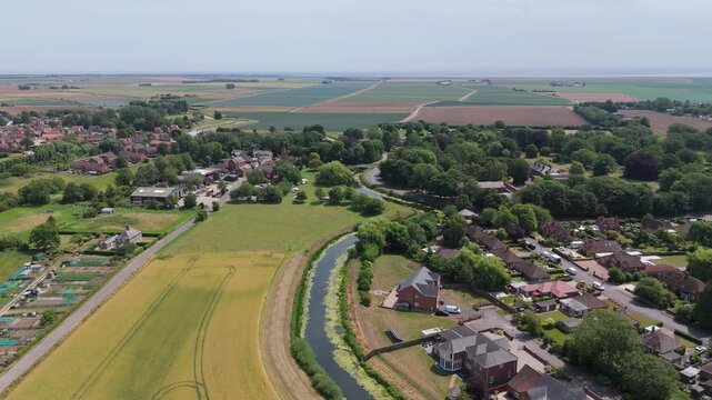 Aerial view of village nestled beside a winding river