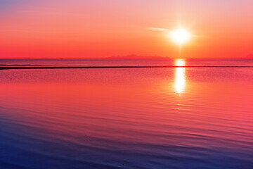 Fototapeta premium Sea beach sunset, ocean sunrise, beautiful tropical island landscape, red orange sky cloud, golden sun reflection, calm blue water waves, peaceful relaxed atmosphere, summer holidays, vacation, travel