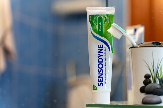 Miercurea Ciuc, Romania- 03 October 2026: Sensodyne Fluoride tooth paste on glass shelve, space for text.