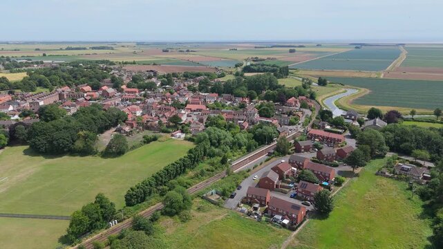 Aerial view of quiet village nestled in green fields