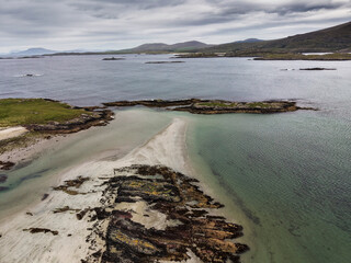 Aerial view of serene coastal inlet, calm waters, rocky shorelines, and distant hills. Overcast sky casts soft light over tranquil scene. Ideal for travel, nature, or environmental themes © mark_gusev