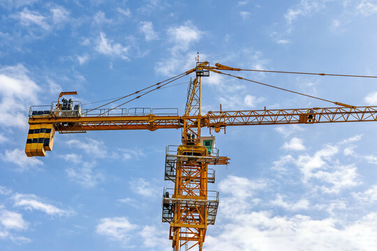 Yellow Tower Crane Against Blue Sky Construction Scene