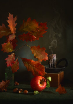 A still life featuring oak branches with beautiful autumn leaves, a ripe apple, and an extinguished candle with a wisp of smoke rising from it, set against a dark background.