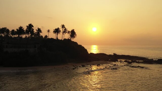 Sunrise over Silent Beach in Tangalle Sri Lanka with Palm Silhouettes