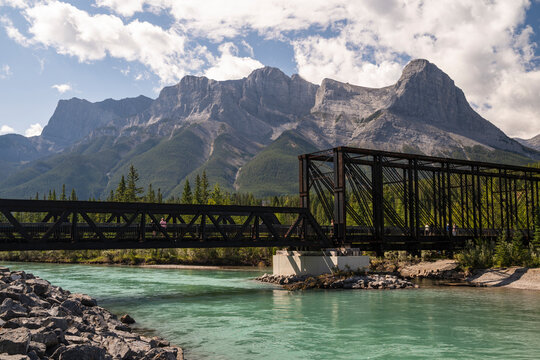 Beautiful view to old iron train bridge with rocky mountains