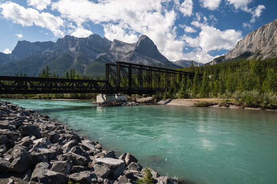 Beautiful view to old iron train bridge with rocky mountains