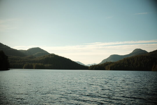 Calm mountain lake with rounded peaks behind