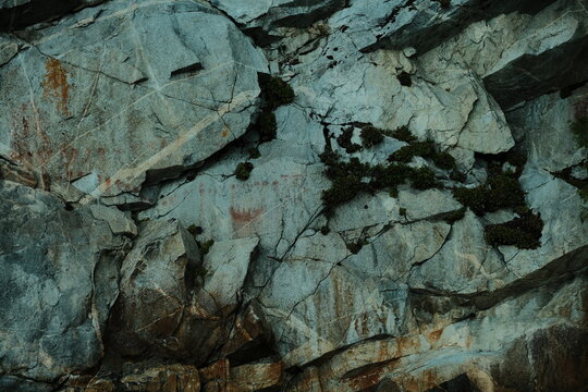 Fractured gray rock face texture close-up