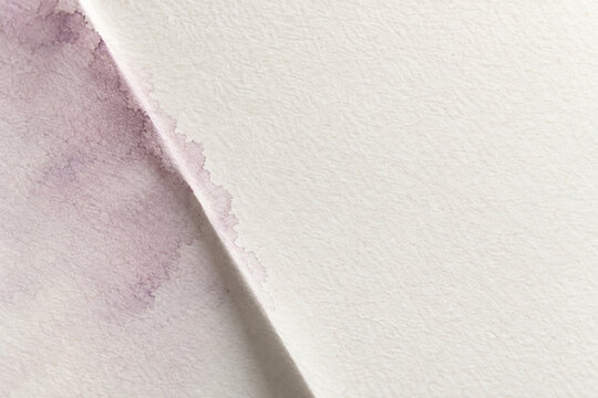 Soft mauve wash around a single folded paper shadow