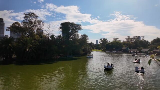 People in paddle boats on a lake in Tres de Febrero Park, Buenos Aires