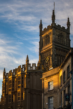 Gothic tower of Church of St John the Baptist illuminated by late sunlight in Cirencester England