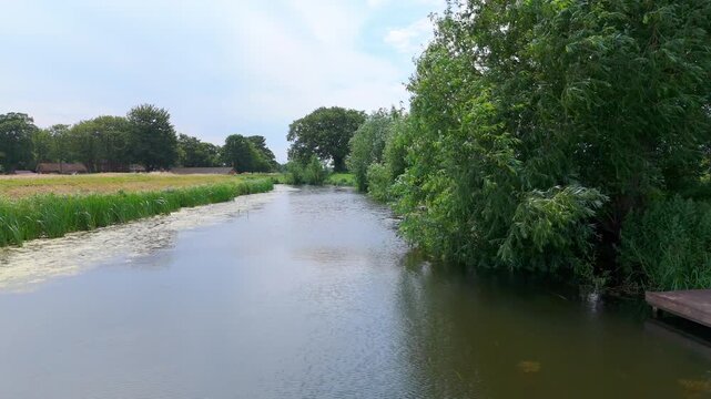 Serene river flows through lush green surroundings