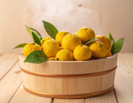 Yuzu citrus fruits in a hinoki wooden bucket for a Japanese winter solstice yuzu bath