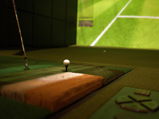 Naklejka premium Golf Ball on Tee in Indoor Golf Simulator