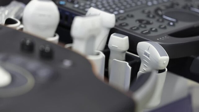 Multiple ultrasound probes arranged in holders on a professional ultrasound diagnostic system.