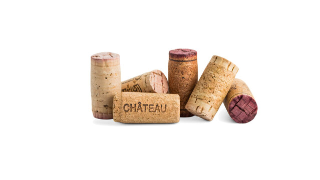 Group of used natural wine corks with text and stains, arranged in a pile on a black background, close up studio of wine corks