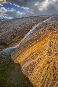 Runoff from Excelsior Geyser Crater into the Firehole River staining the banks red, at the entrance to Midway Geyser Basin. Yellowstone NP-WY-USA-028
