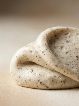 Close up of creamy dough with specks on a smooth surface for baking