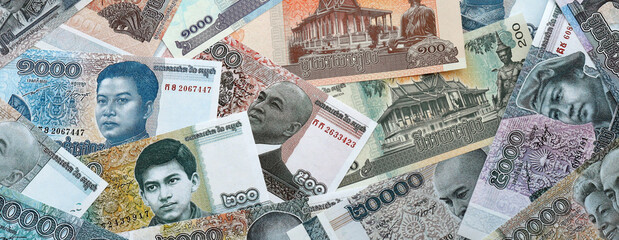 Cambodian riel money banknotes pile on table. Cambodia bills of KHR currency close up © Larysa