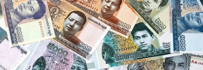 Cambodian riel money banknotes bunch on table. Cambodia bills of KHR currency close up © Larysa